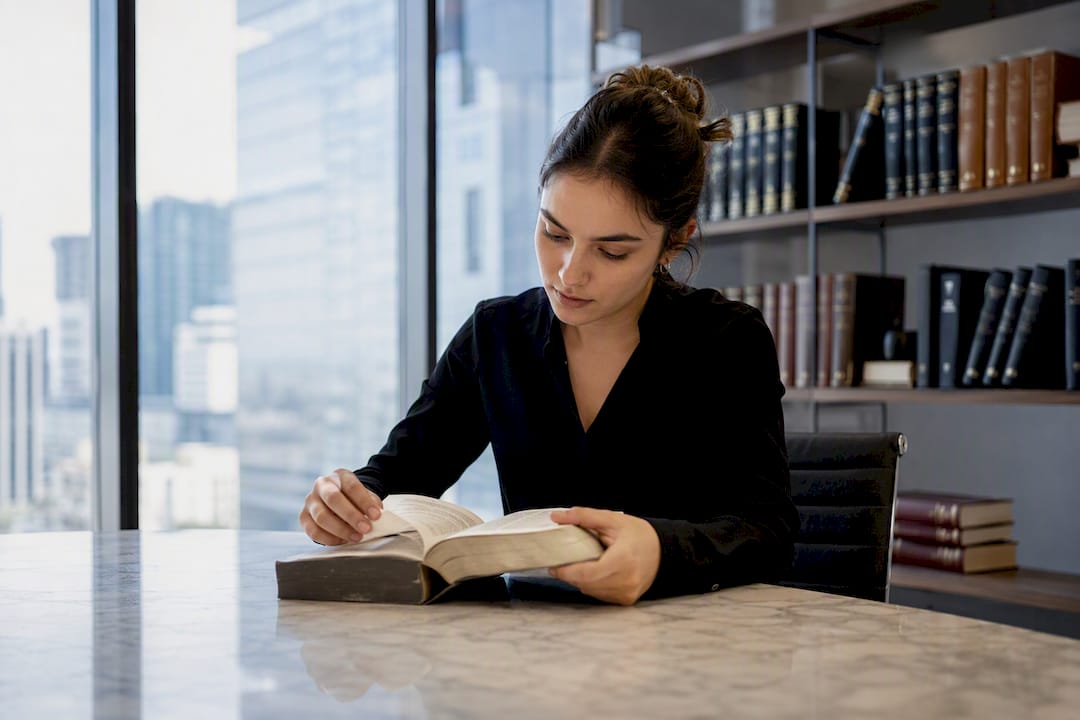 Hands selecting a legal book in law library